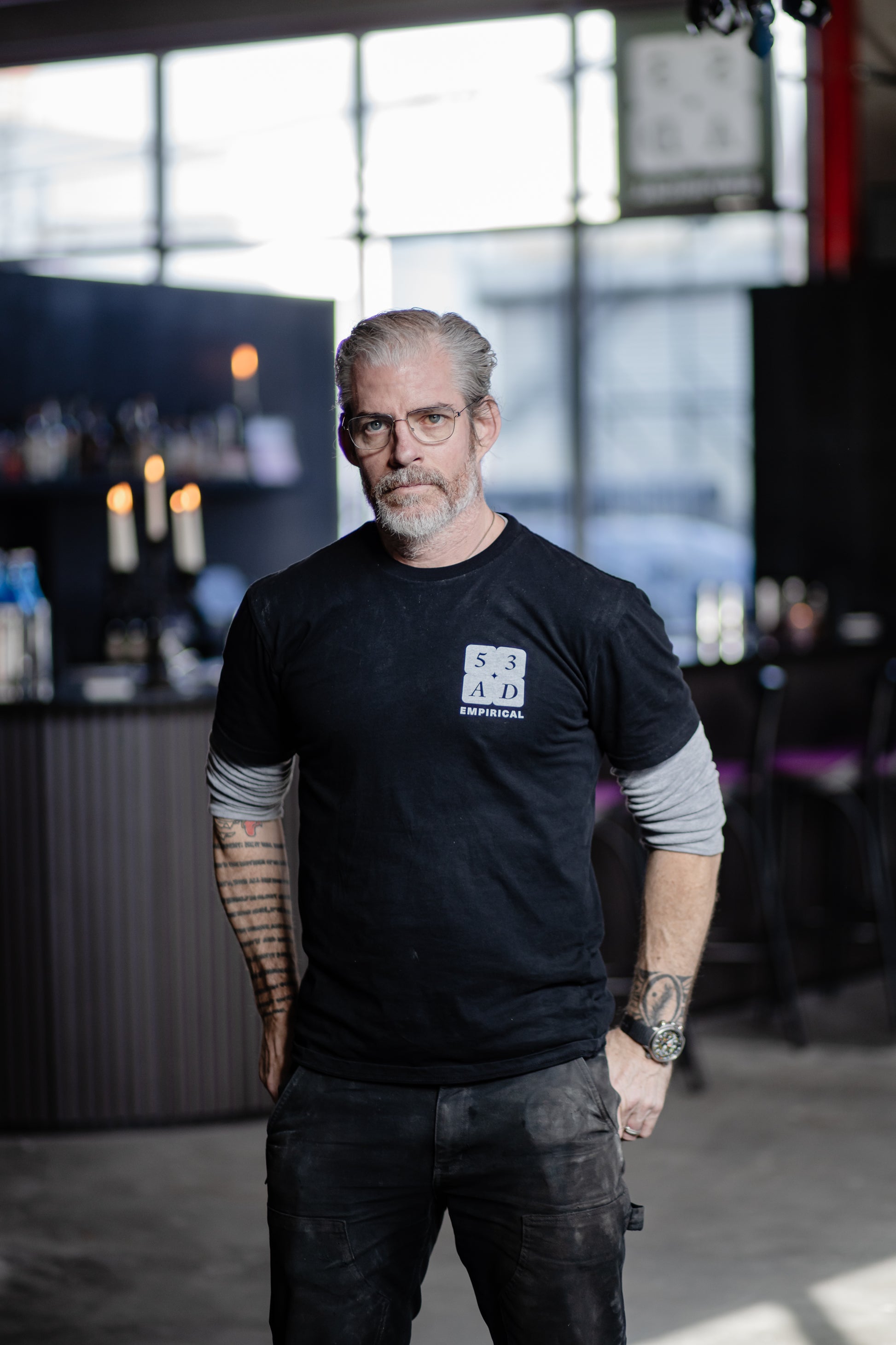 Empirical staffer wearing the 53AD tee inside the bar at 53AD Brooklyn