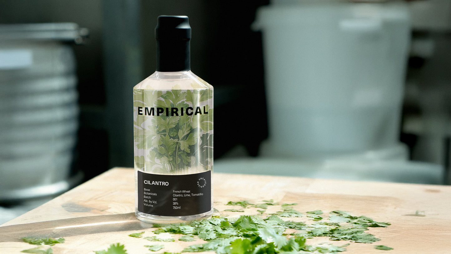 Behind-the-scenes journal still: Empirical Cilantro bottle with a finished cocktail