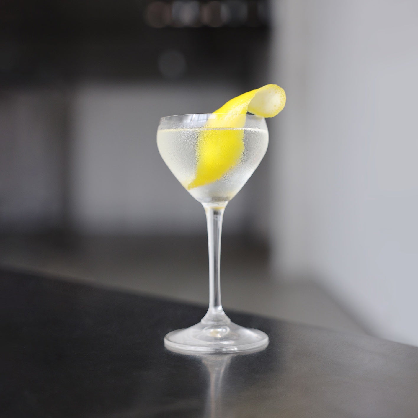 Cilantro Martini in a coupe glass with lemon twist garnish