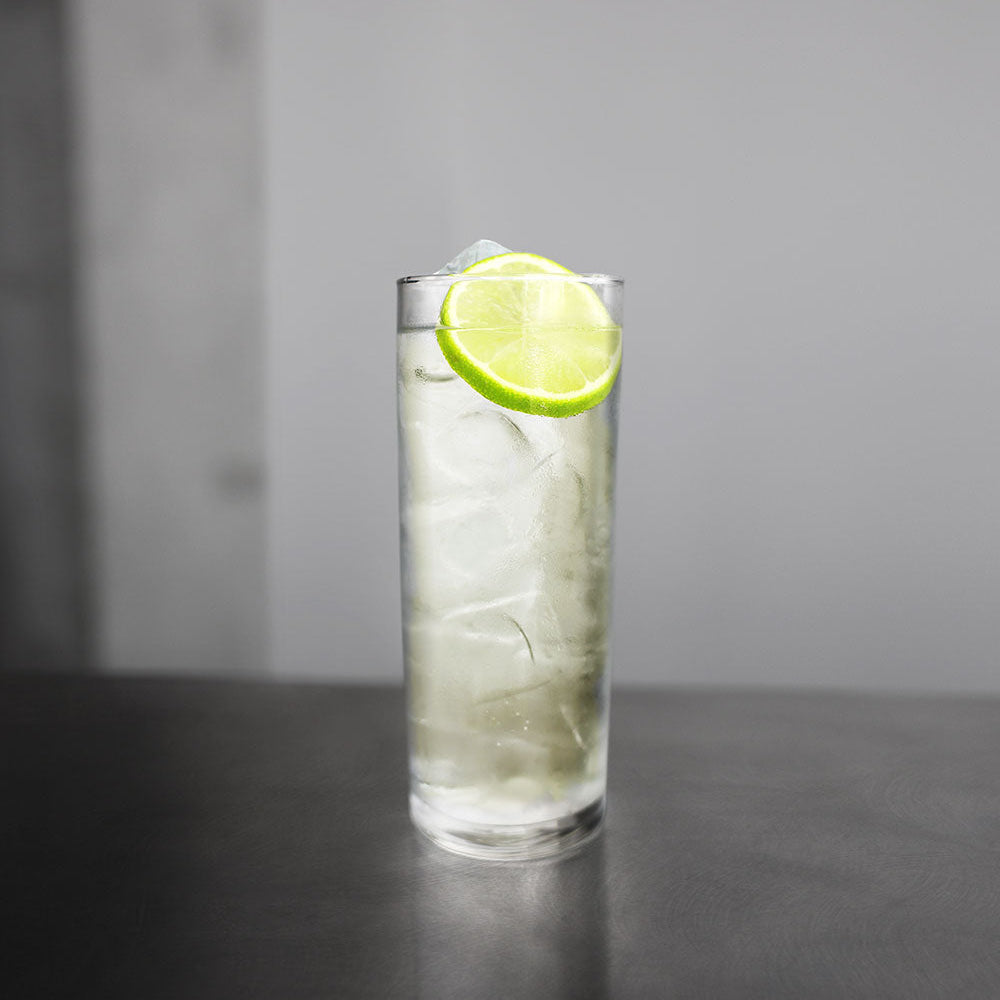 Cilantro & Yuzu highball in a tall glass with lime wheel