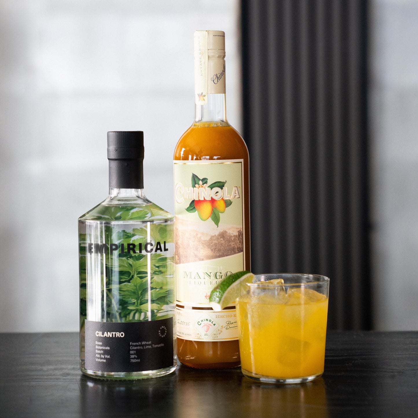 Empirical Cilantro and Chinola Mango bottles photographed together