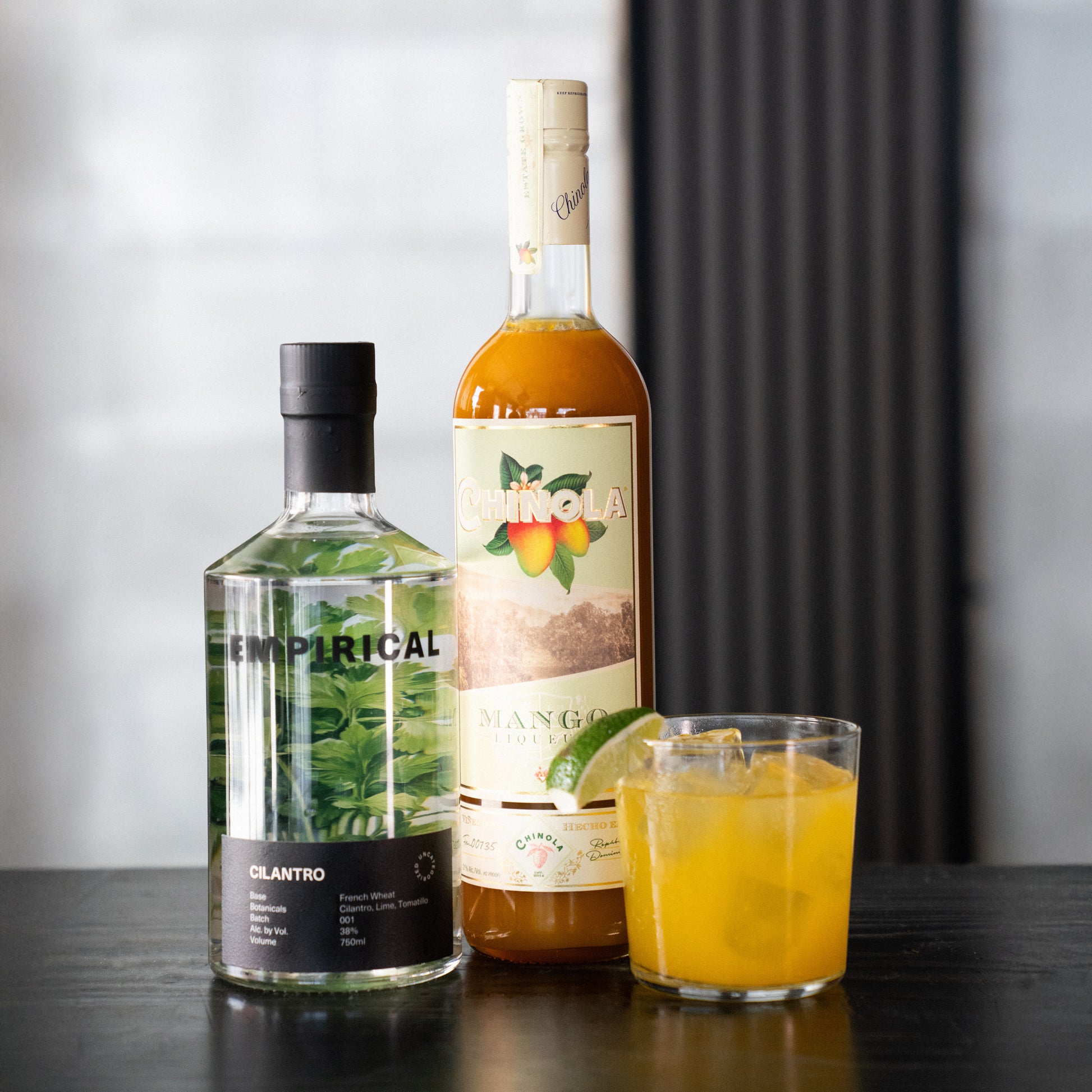 Empirical Cilantro and Chinola Mango bottles photographed together