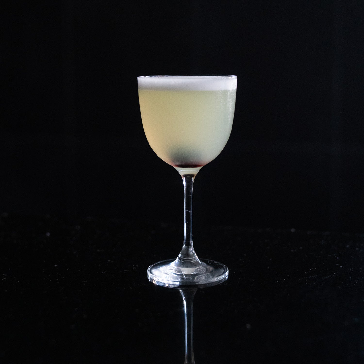Pale yellow cocktail in a Nick & Nora glass — Cilantro & Centerbe pairing