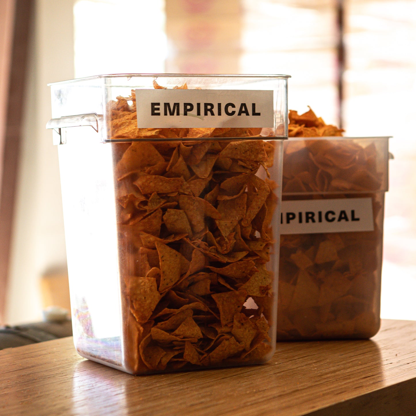 Containers of crushed Doritos chips labeled EMPIRICAL, ready for infusion