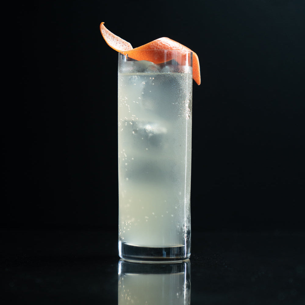 Empirical x Frederick with Gold Thread tonic in a tall glass with grapefruit peel
