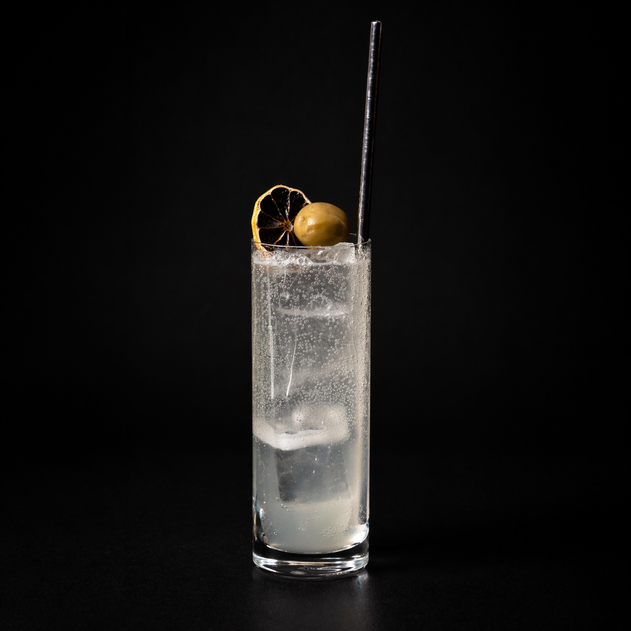 Empirical Olive highball cocktail with olive garnish and dried citrus wheel