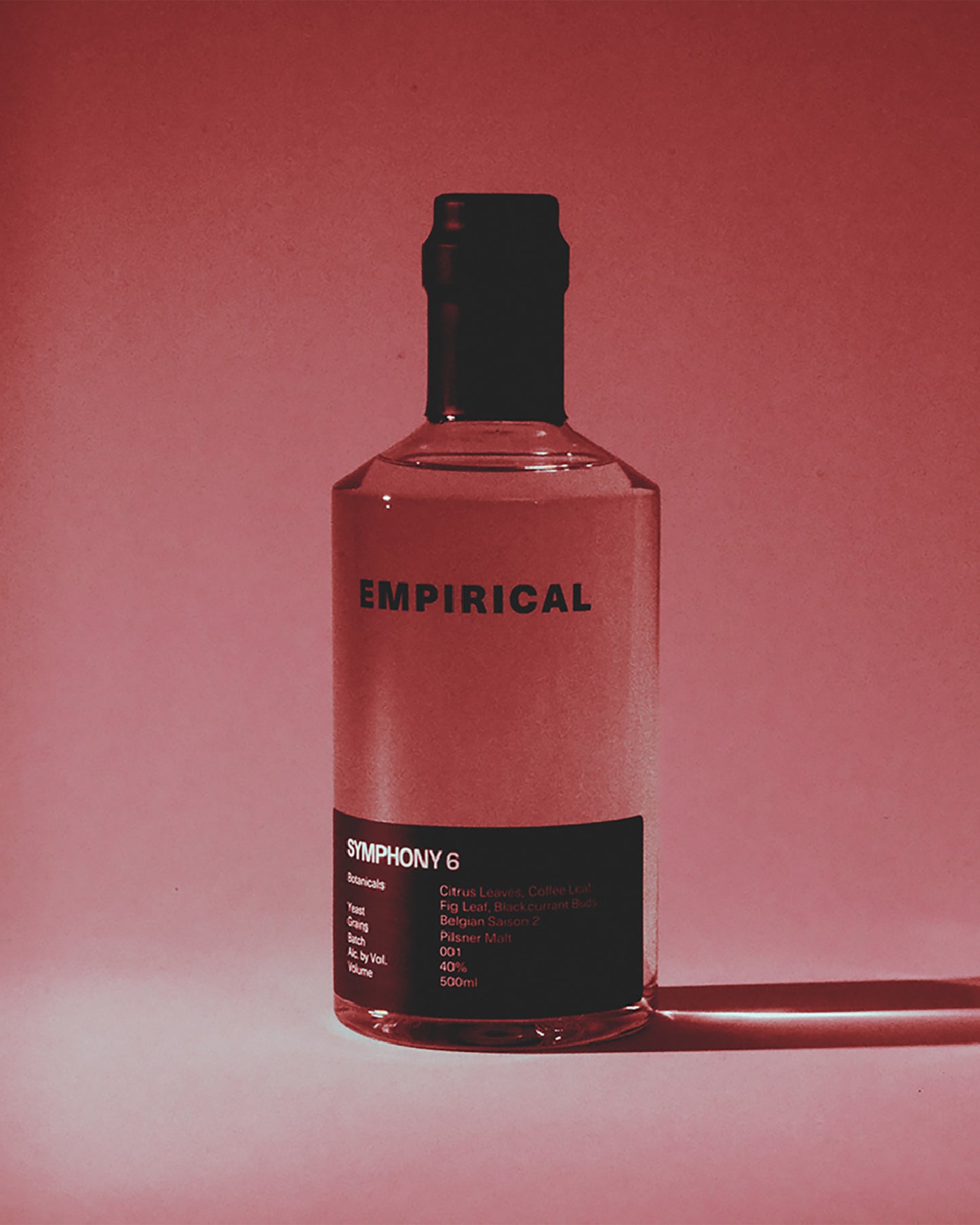 Empirical Symphony 6 bottle photographed in dramatic red light
