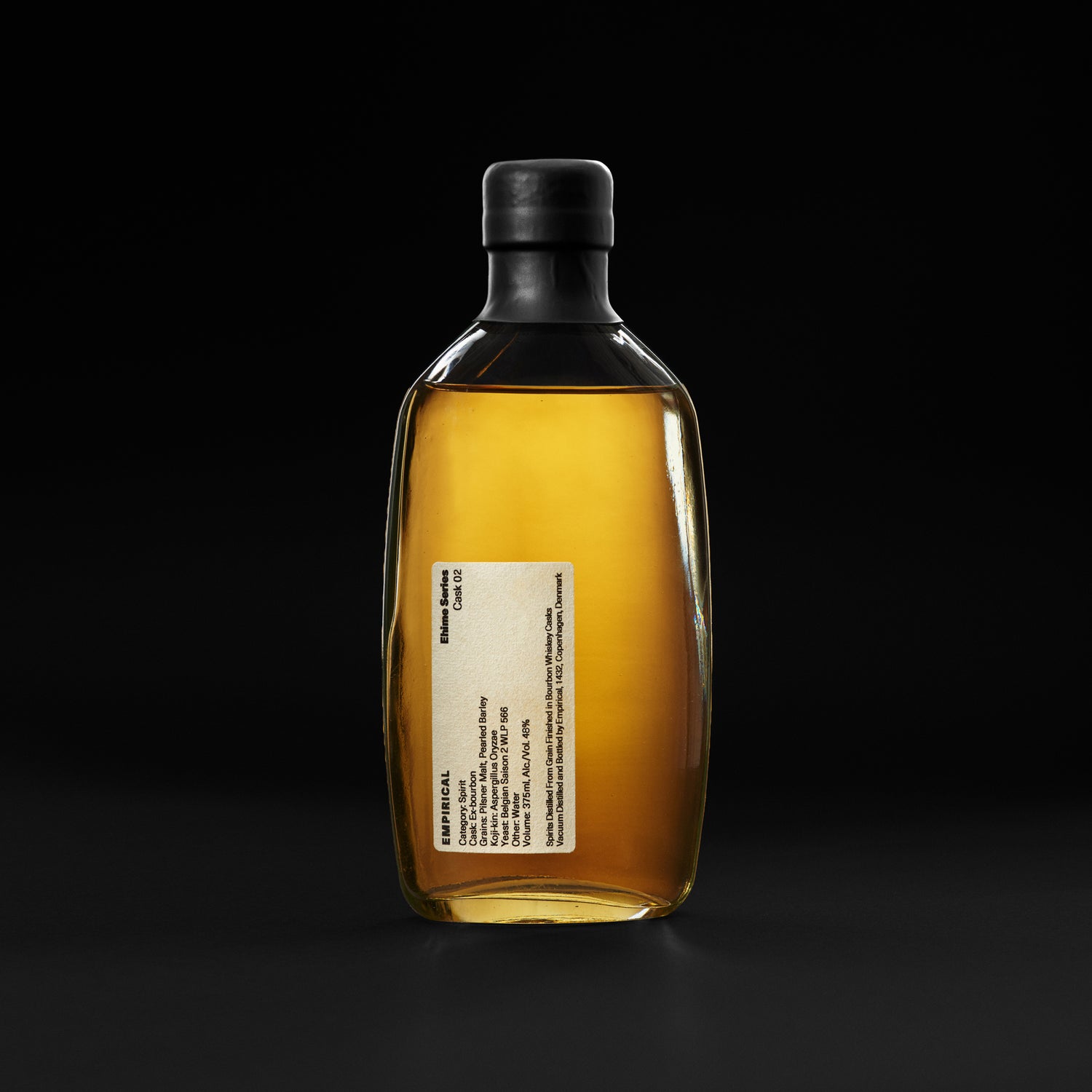 Empirical Ehime Cask 02 bottle on a black background, amber spirit