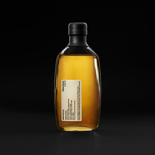 Empirical Ehime Cask 03 bottle on a black background, amber spirit