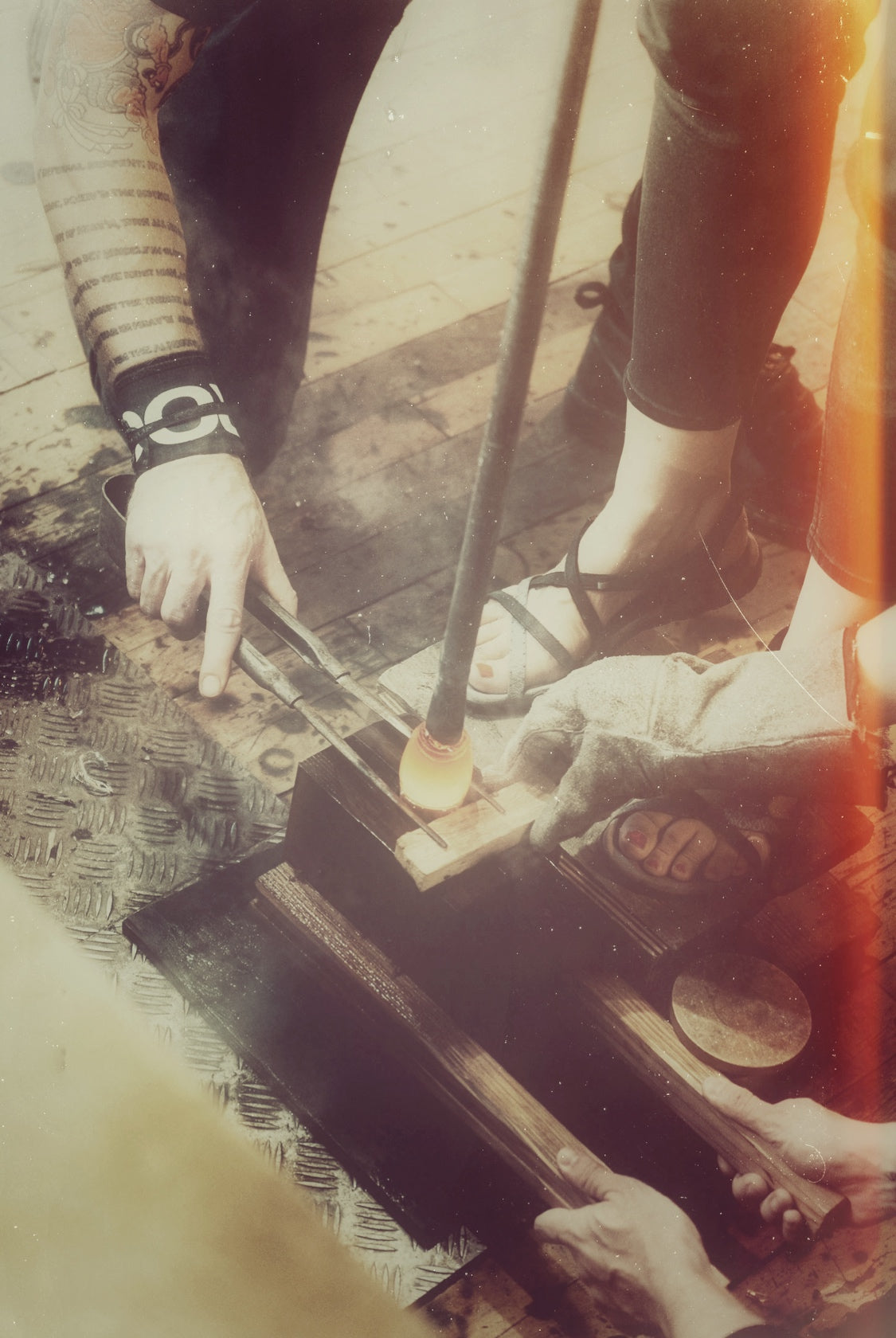 Hands shaping the rim of a hot glass bottle for the Ehime Cask series