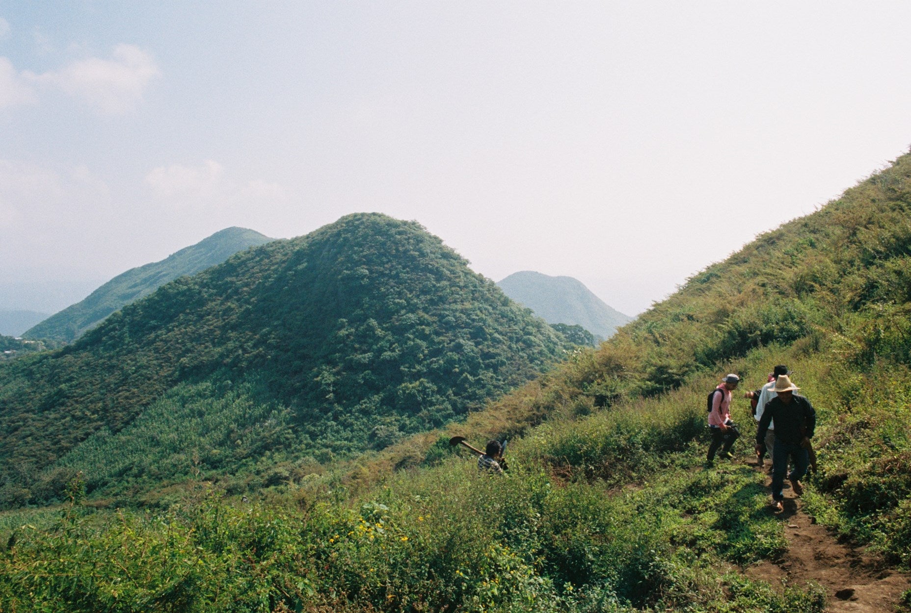 Hikers on a Sierra Mixe ridge in Oaxaca, the landscape behind Ayuuk